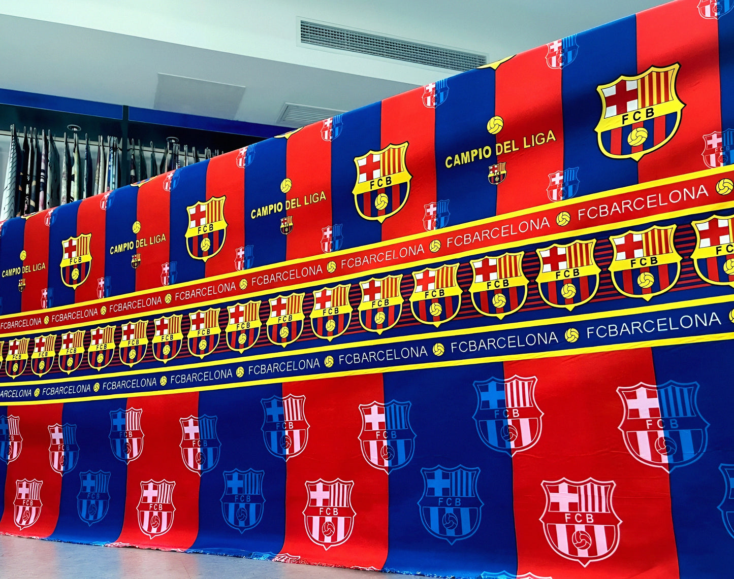 FC Barcelona-themed bedsheet in team colors with crest-inspired motif, neatly styled on bed for fans.