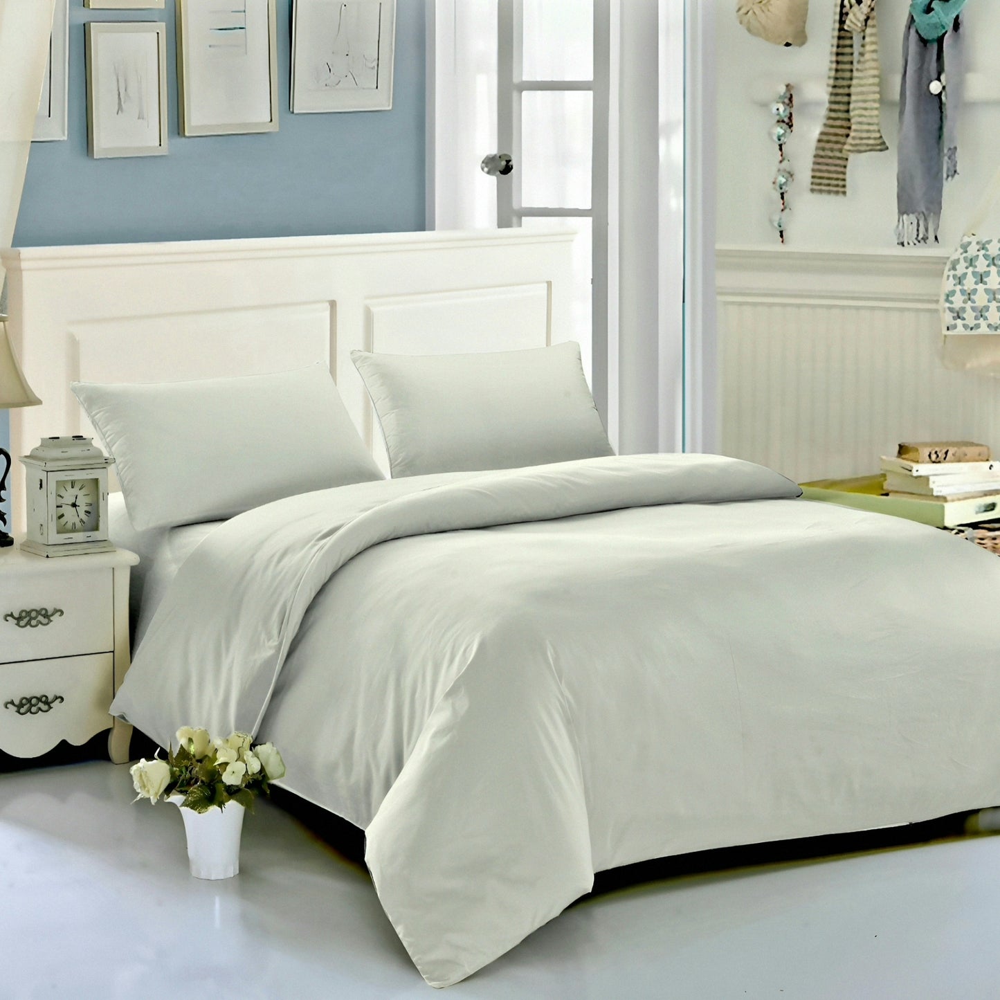 Neatly made bed with white bedding in a bedroom setting.