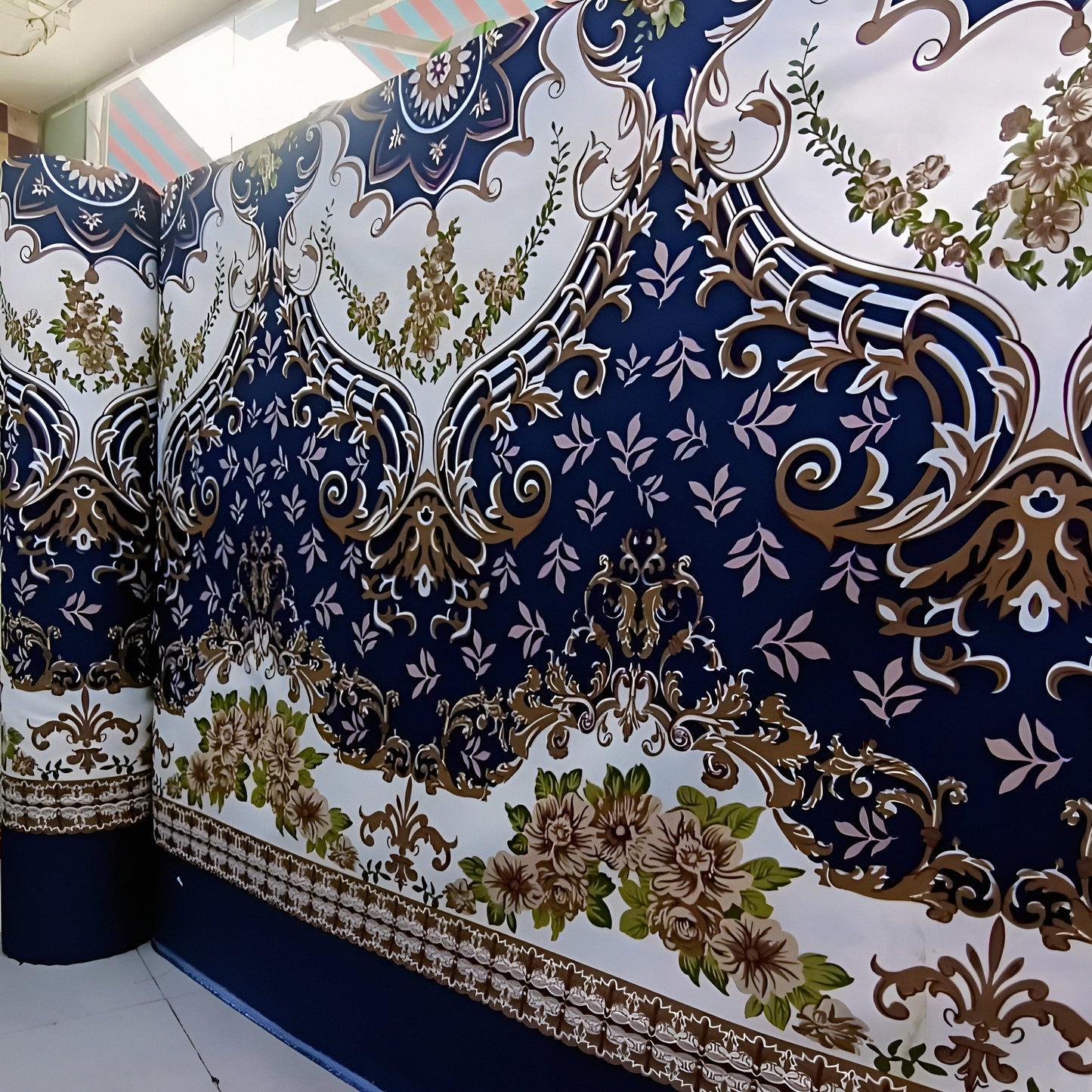 Cotton-blend bedsheet in navy featuring a gold floral design with intricate white details.