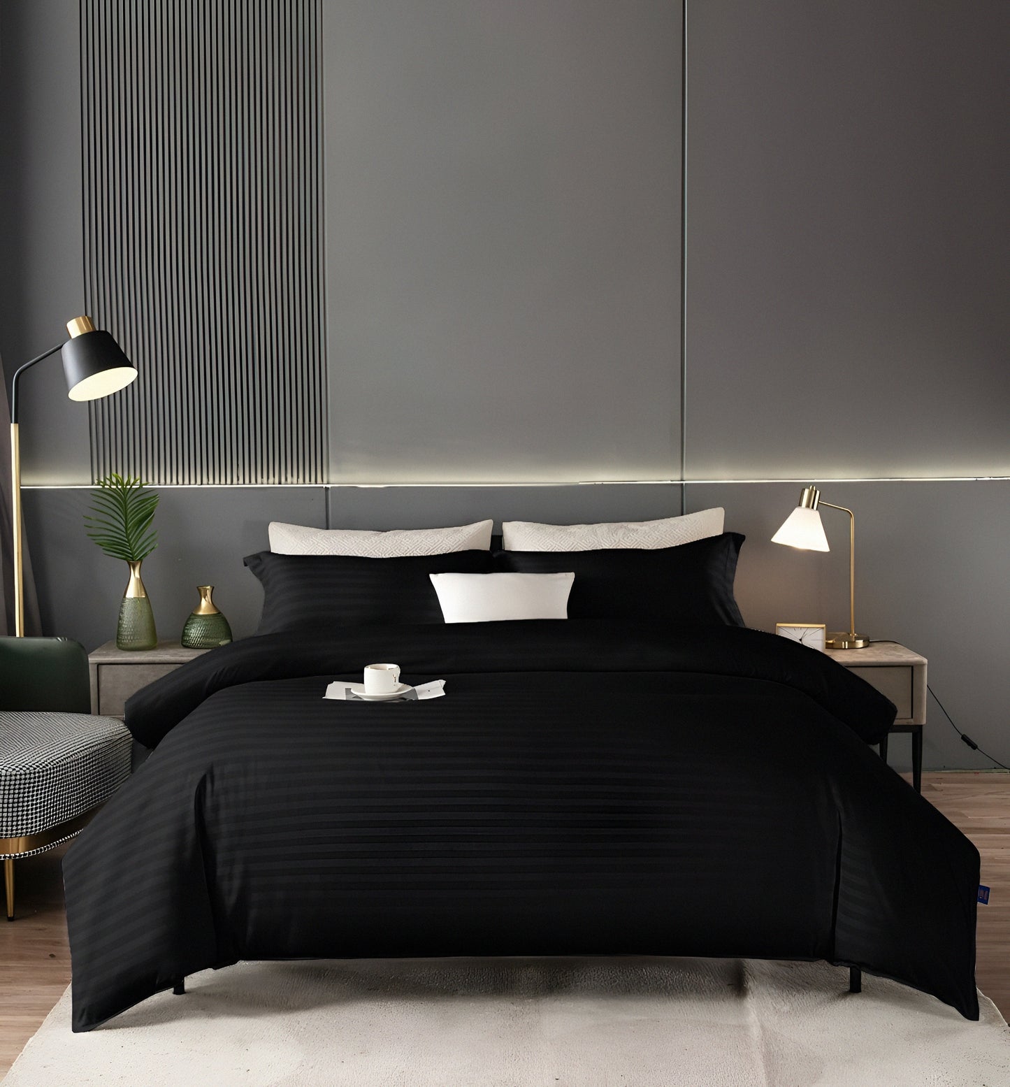 A full bedsheet set in solid black, including a flat sheet, fitted sheet, and two pillowcases.