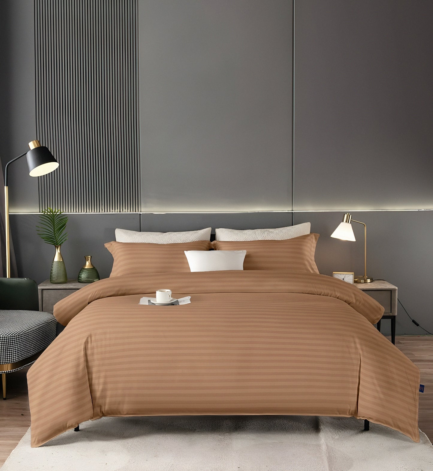 Brown striped bedding set on a bed in a modern bedroom with gray walls and minimal decor.