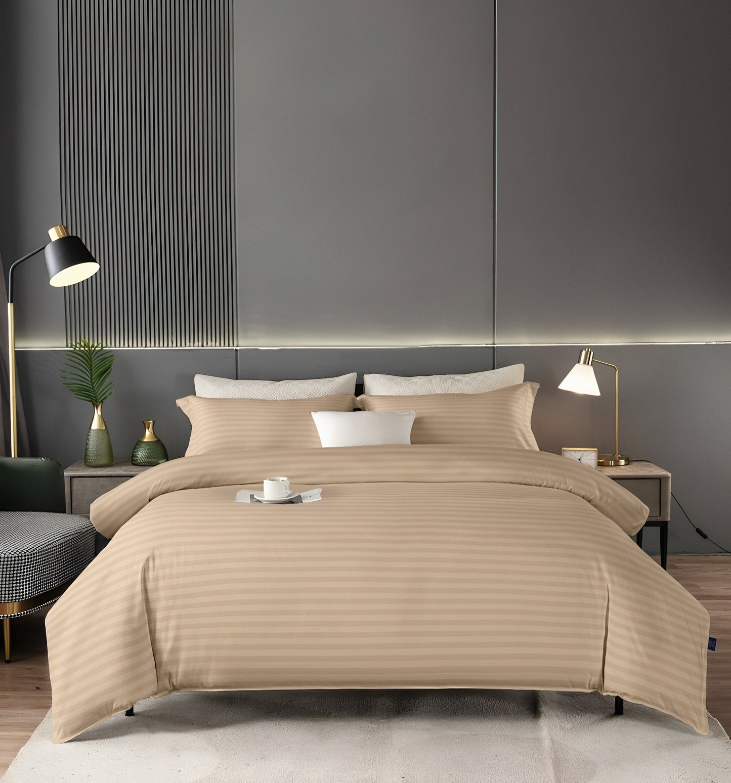 A neatly made double bed with a fitted plain beige bedsheet and two standard pillowcases.
