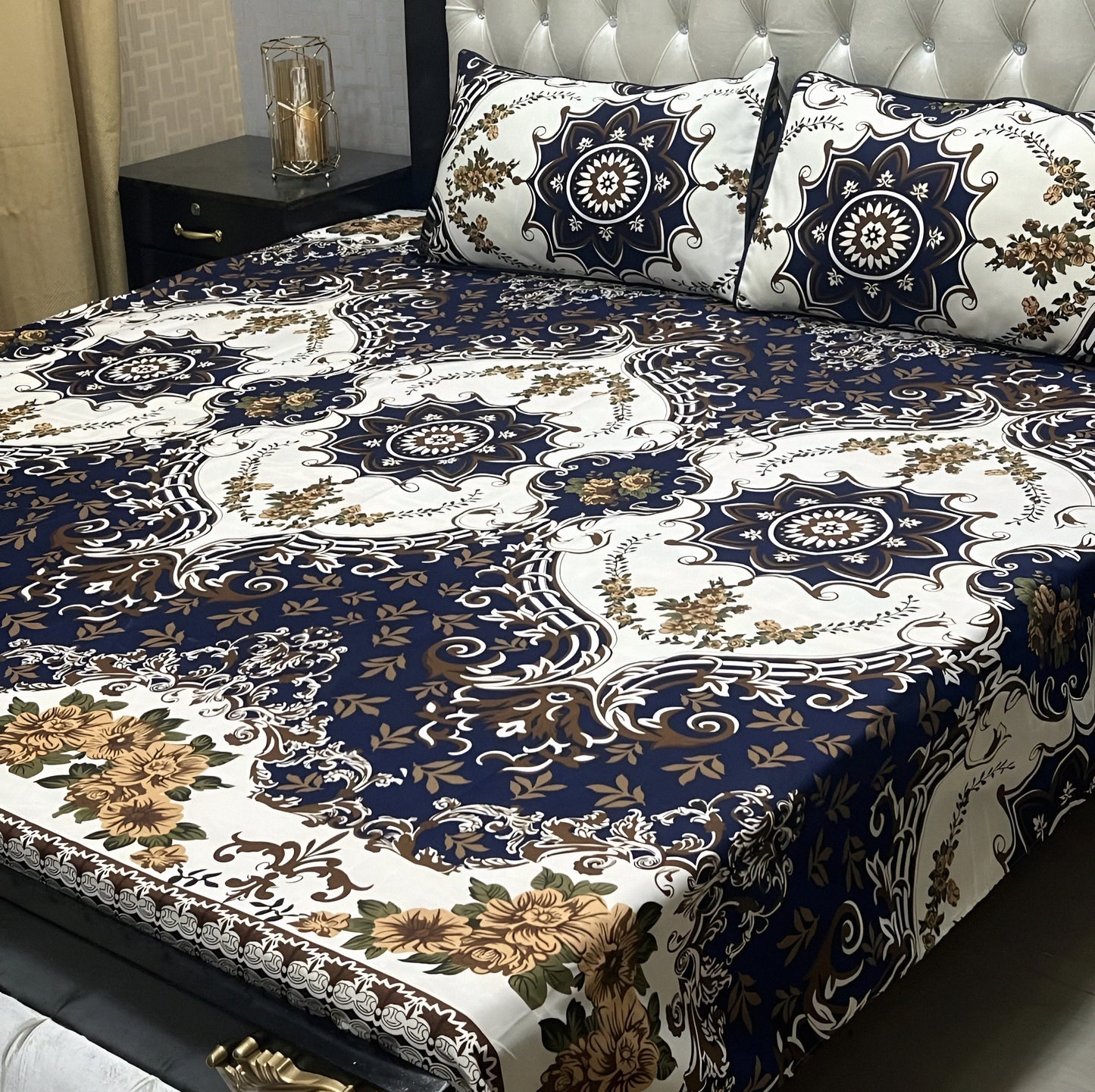 Luxury navy blue bedsheet with gold floral pattern and ornate white detailing.