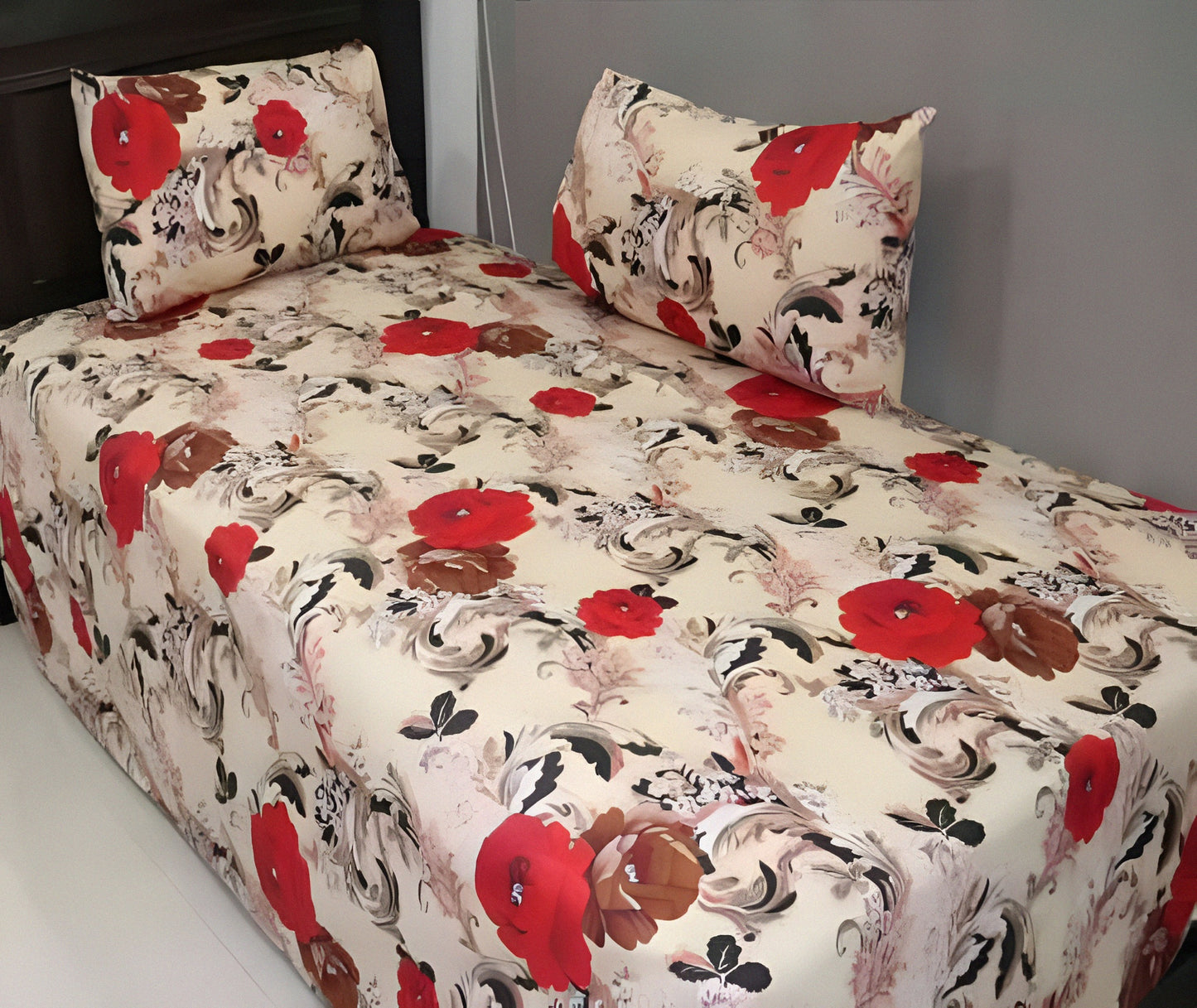 Red floral cotton bedsheet with bold red and brown flower design on cream background, neatly spread with matching pillowcases.