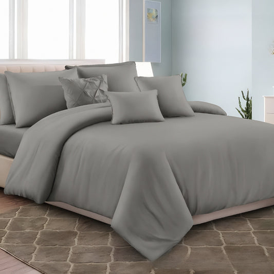 Charcoal solid bedsheet set styled on a modern minimalist bed with matching pillowcases and bedside decor