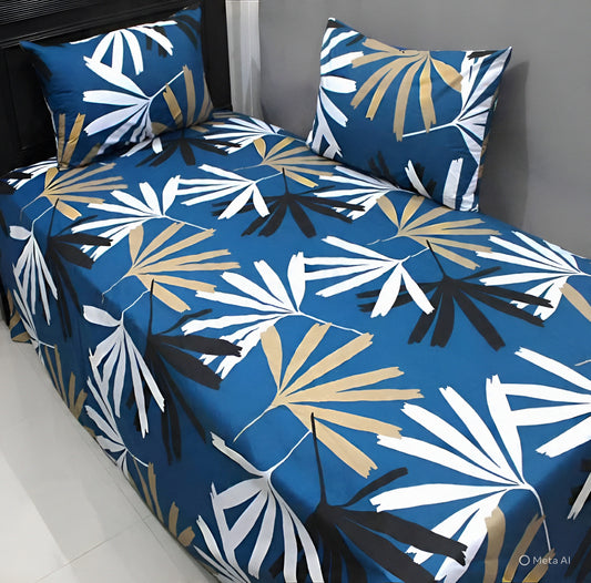 Blue mixed cotton bedsheet with beige, black, and white leaf print design, styled neatly on bed with matching pillow covers.