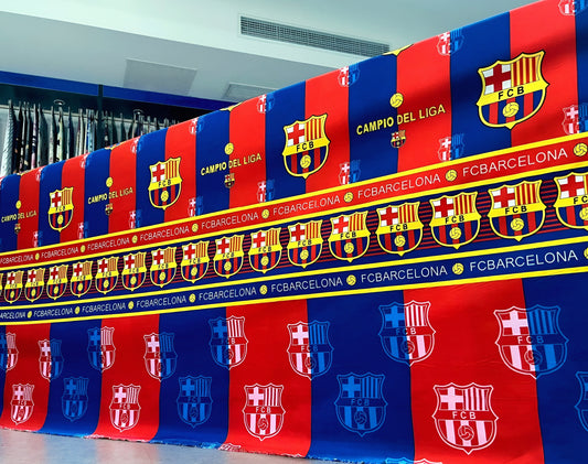 FC Barcelona-themed bedsheet in team colors with crest-inspired motif, neatly styled on bed for fans.