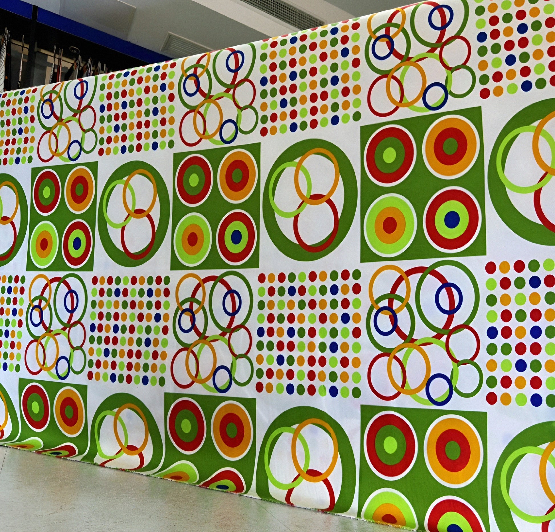 Ready-made circle print bedsheet in vibrant green, red, yellow, and blue.