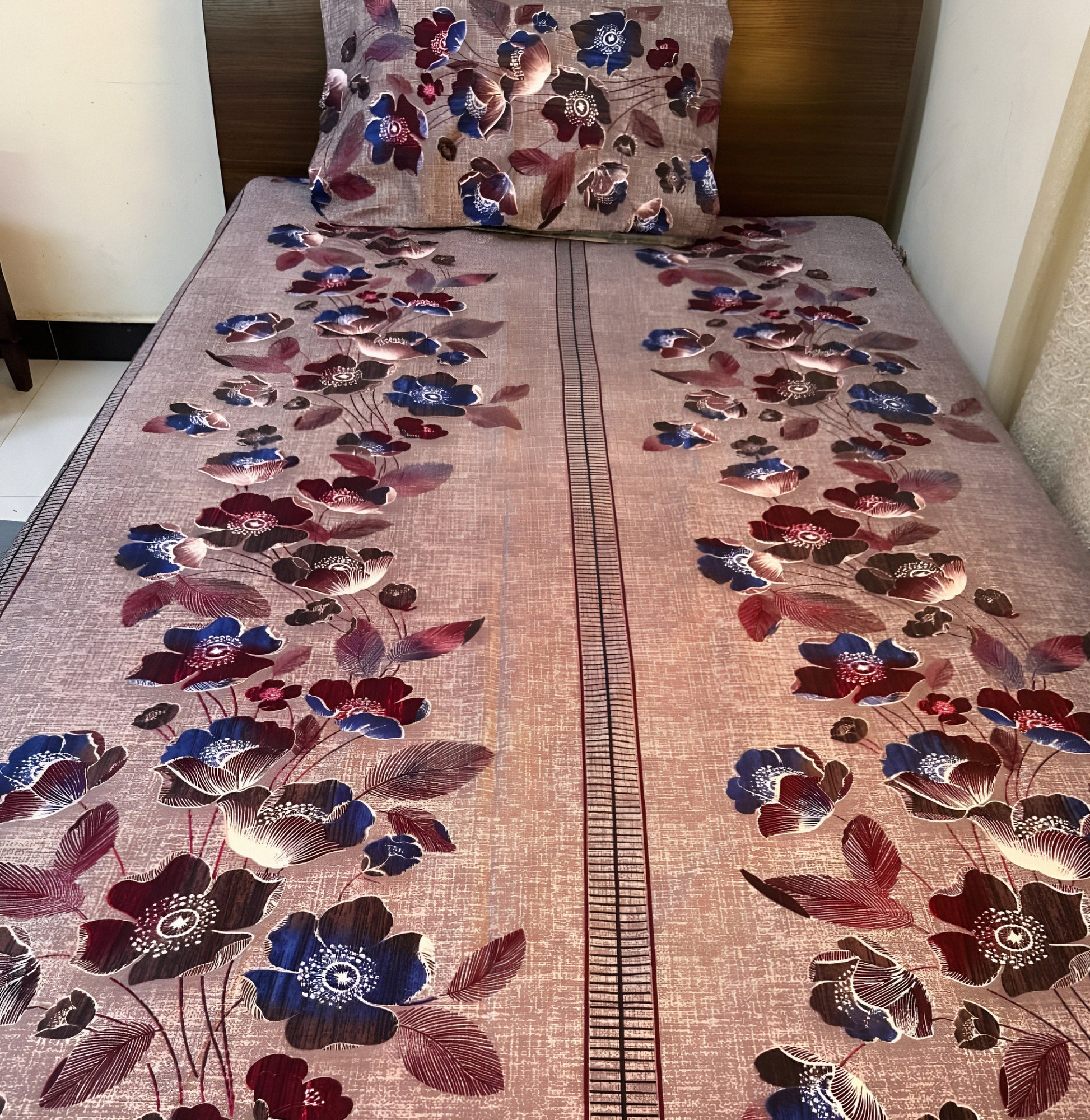 Elegant floral bedsheet with pink & blue blossoms on textured grey background, styled on a single bed — Marjan3x UAE