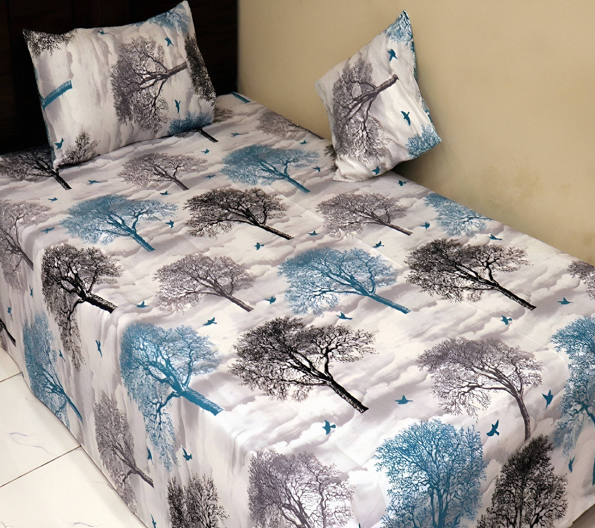 Rolled gray cotton blend bedsheet with a tree print design, highlighting the fabric’s texture.