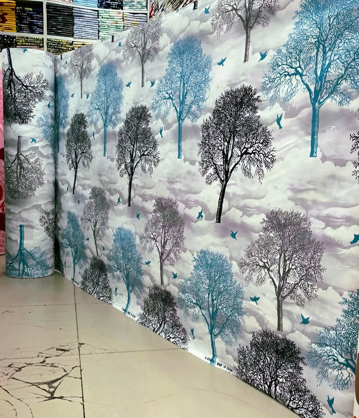 Folded gray bedsheet with a tree print pattern, emphasizing its soft cotton-blend fabric.