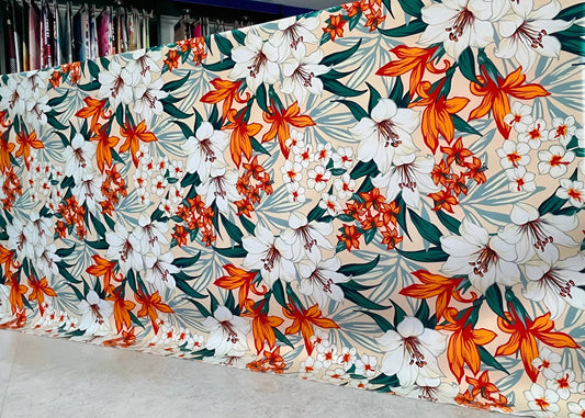 Marjan3x luxury floral bedsheet roll with white & orange lilies — wholesale sizes available. شرشف بنقشة زهور أبيض وبرتقالي، متاح بالجملة وبمقاسات متعددة