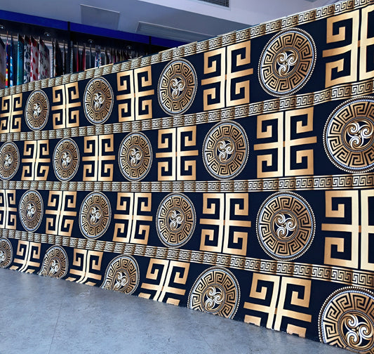 Black bedsheet with gold geometric pattern displayed in showroom — luxury solid-color bedding.