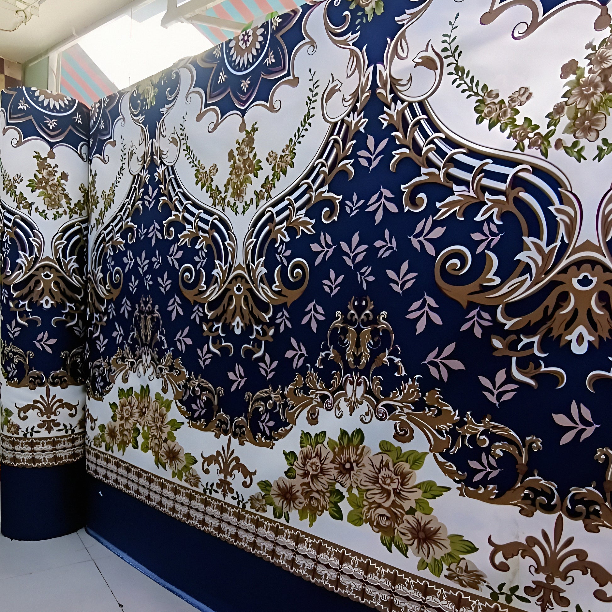 Cotton-blend bedsheet in navy featuring a gold floral design with intricate white details.