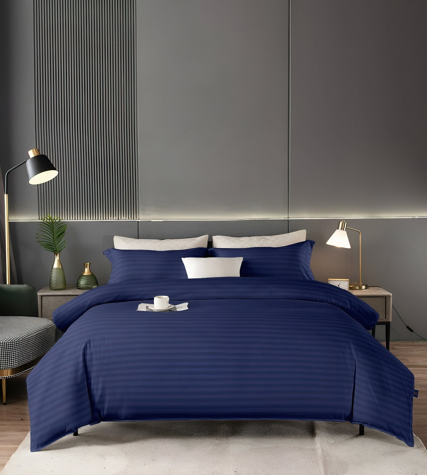 Navy Blue striped bedding set on a bed in a modern bedroom with gray walls and decorative elements.