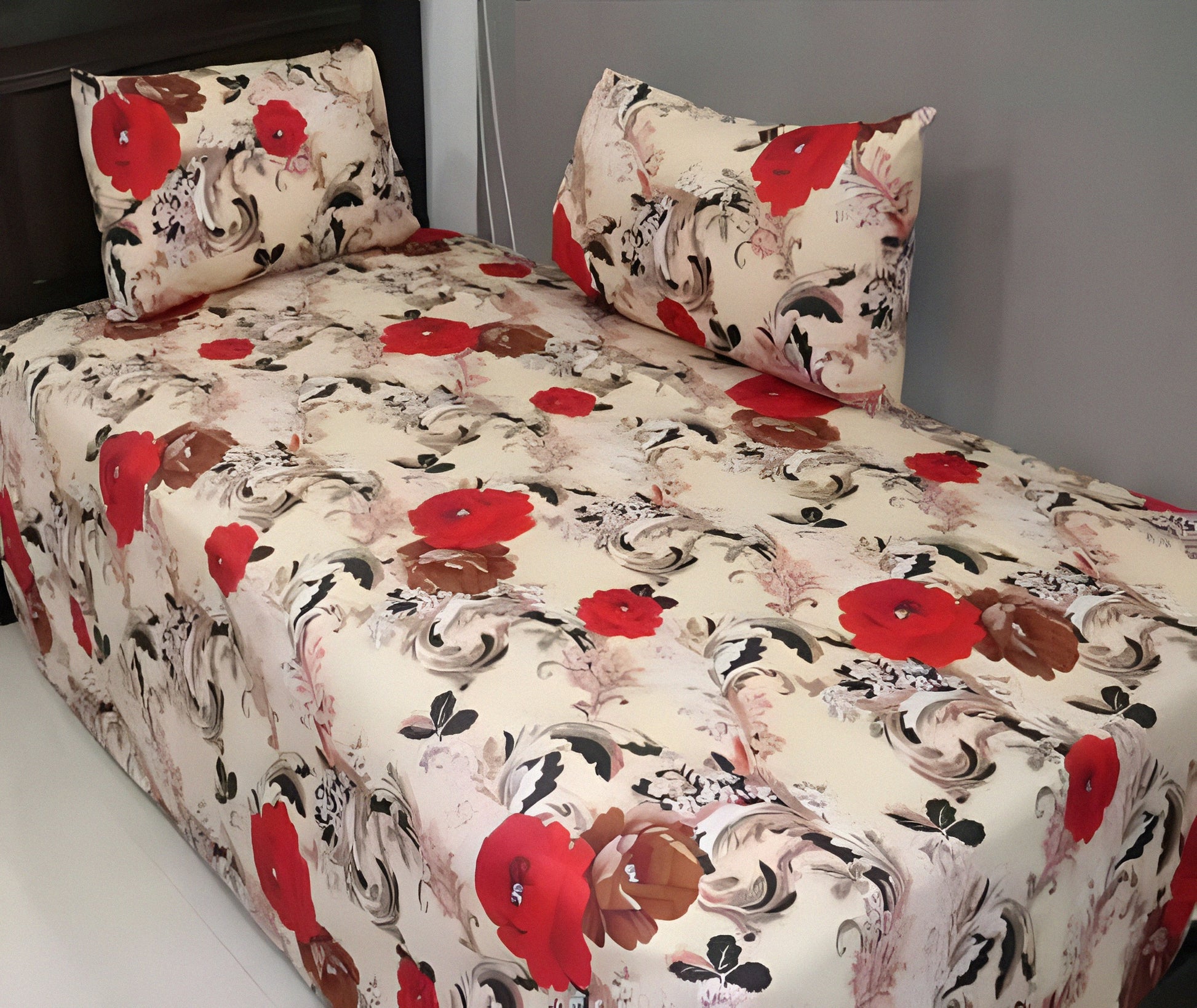 Red floral cotton bedsheet with bold red and brown flower design on cream background, neatly spread with matching pillowcases.