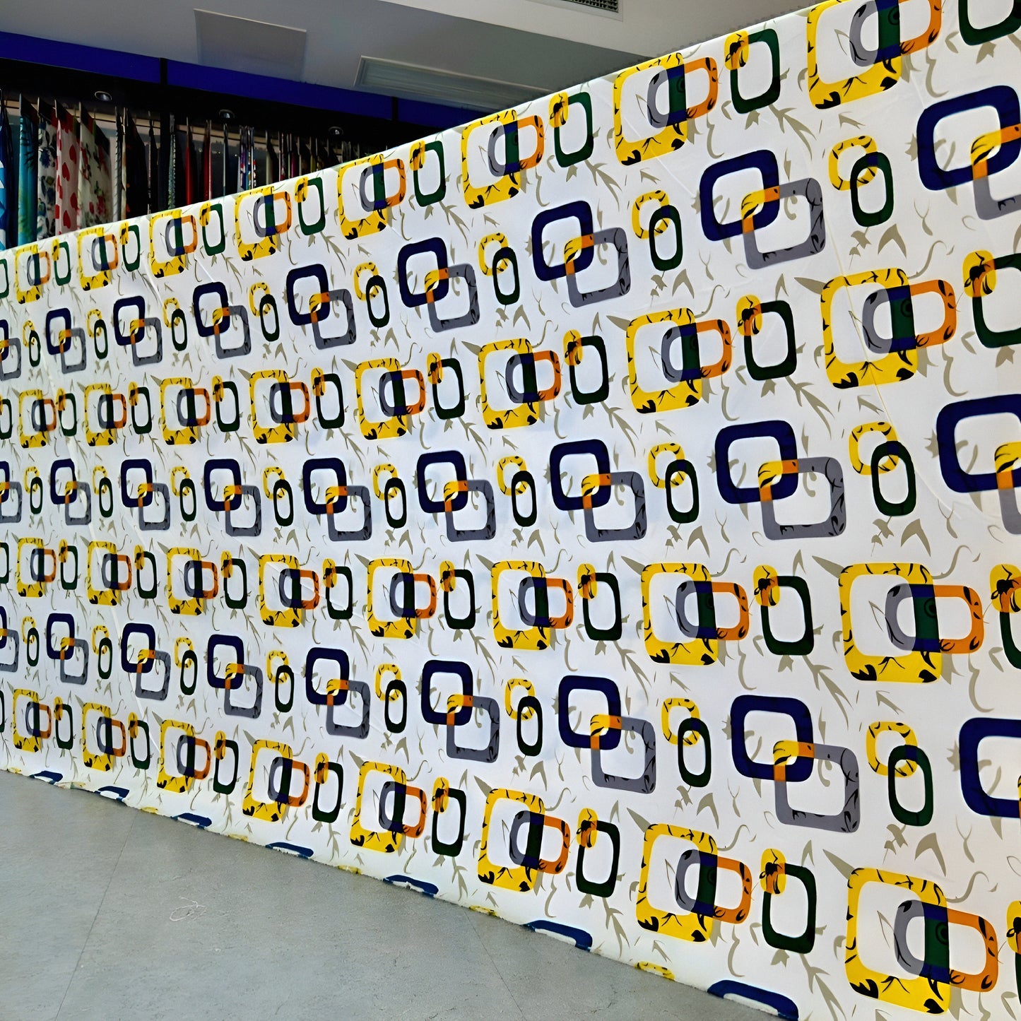 Wall with a pattern of colorful geometric shapes in a room.