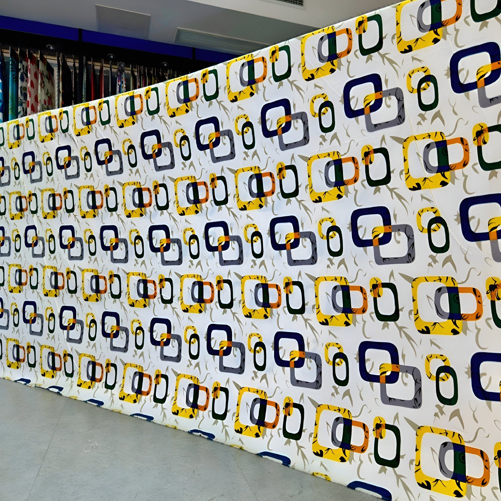 Wall with a pattern of colorful geometric shapes in a room.