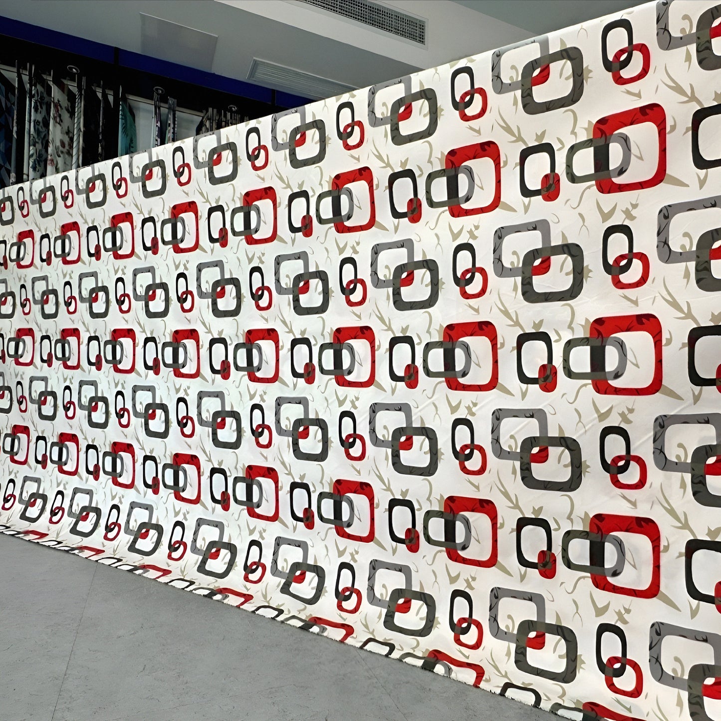 Red bedsheet roll with multicolor geometric print and pillows