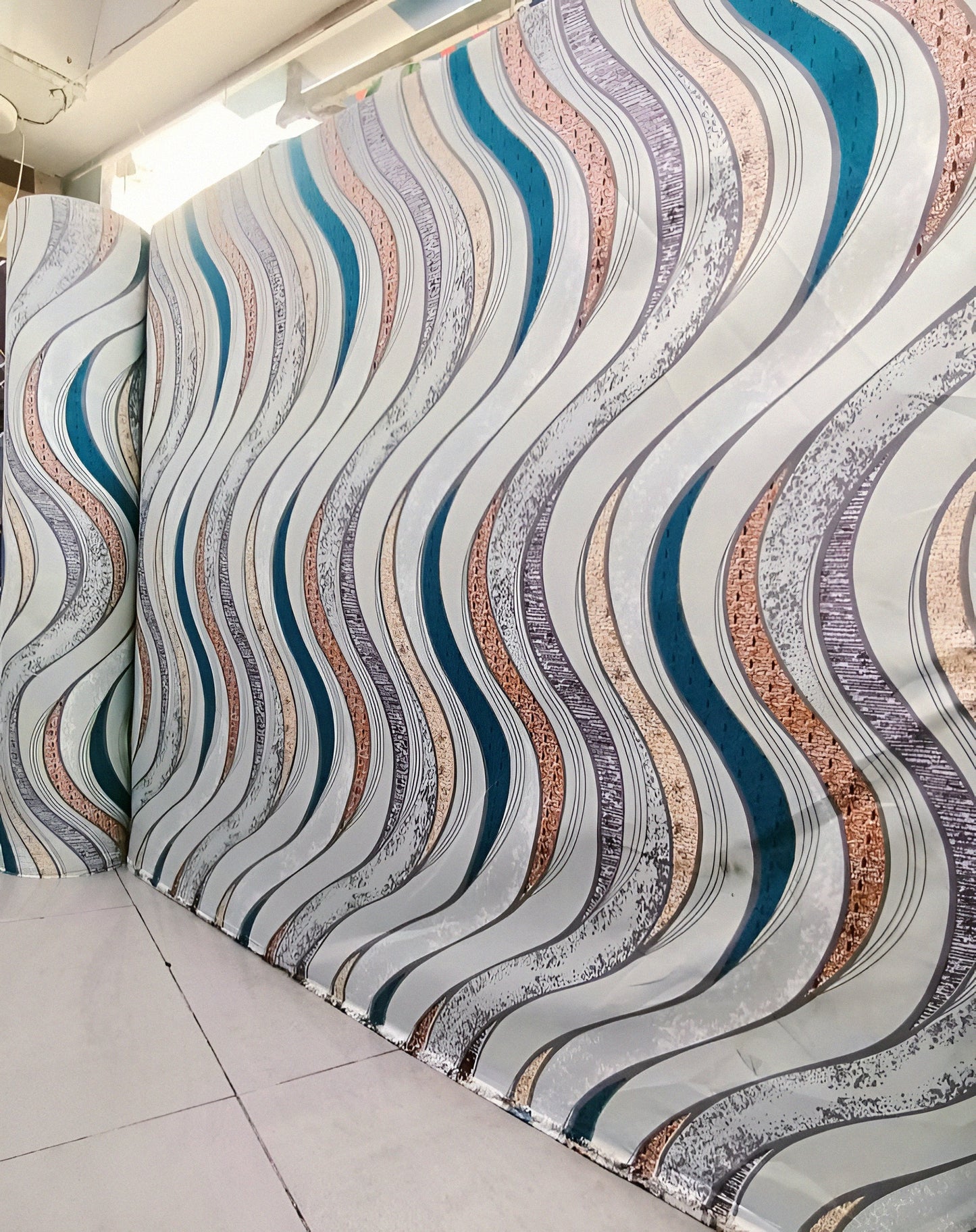 Marjan3X silver cotton bedsheet featuring a wave design with teal and copper brown accents.