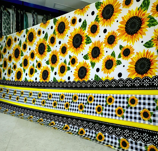 White bedsheet with bright sunflower floral print on display